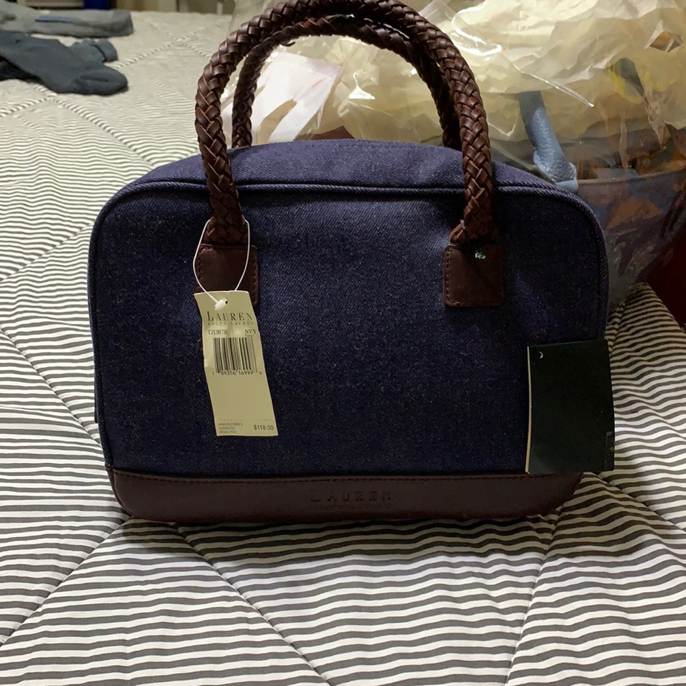 Brand new Ralph Lauren satchel bag.the bag has leather trim with woven handles.
